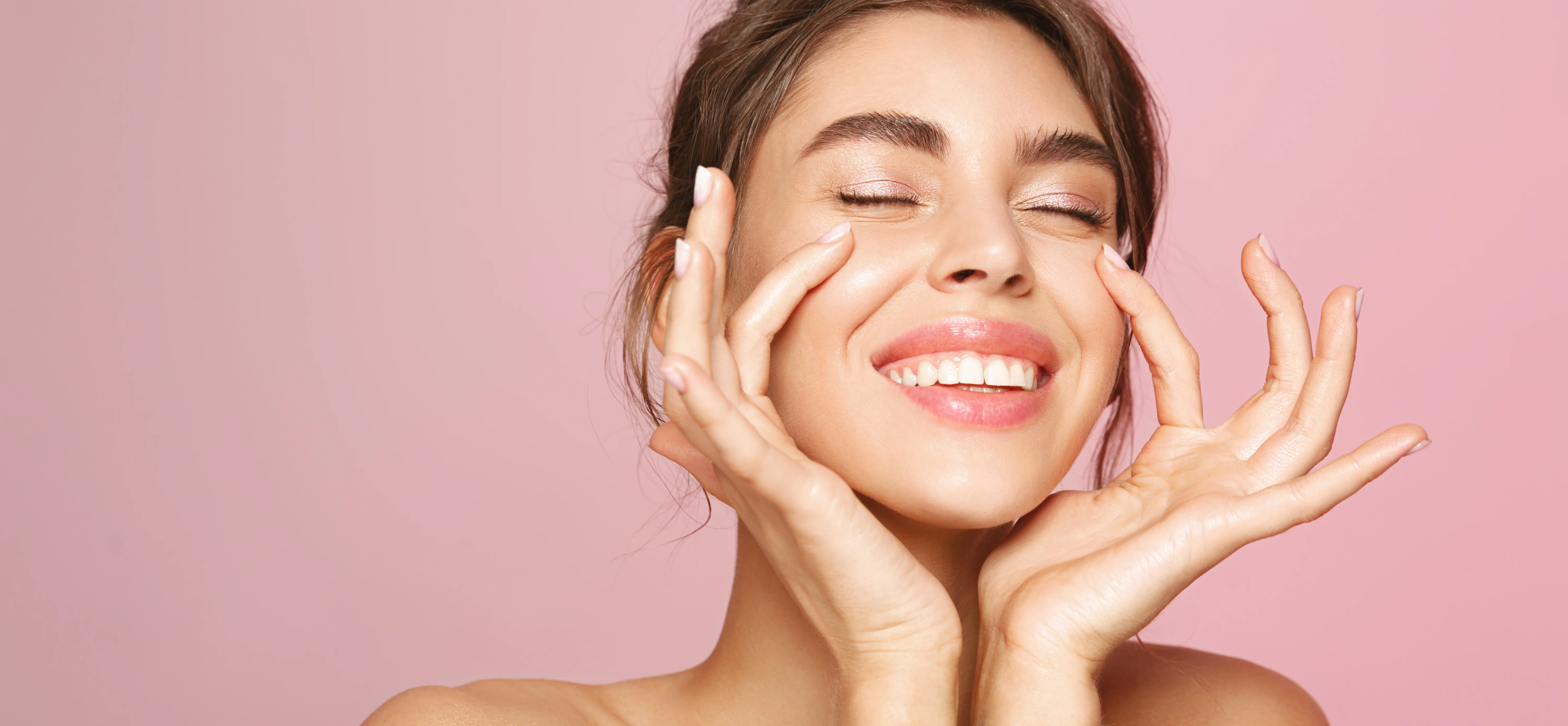 Woman checking her skin in a mirror after a laser treatment